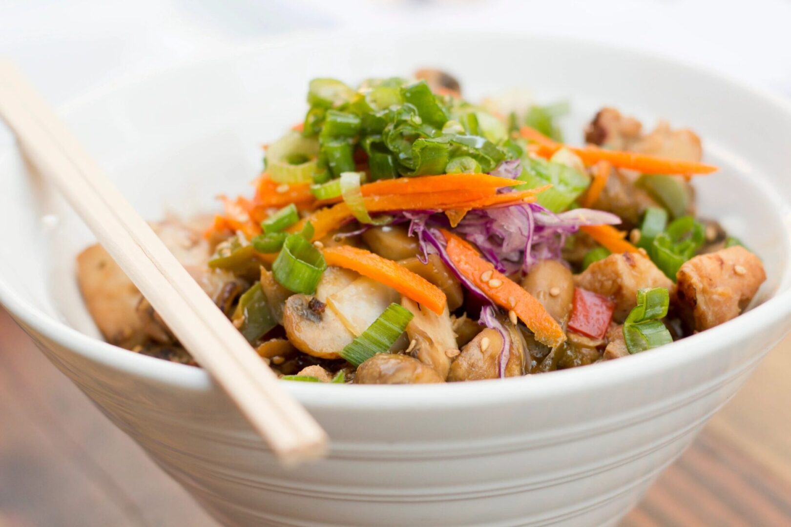 A bowl of food with chopsticks in it.