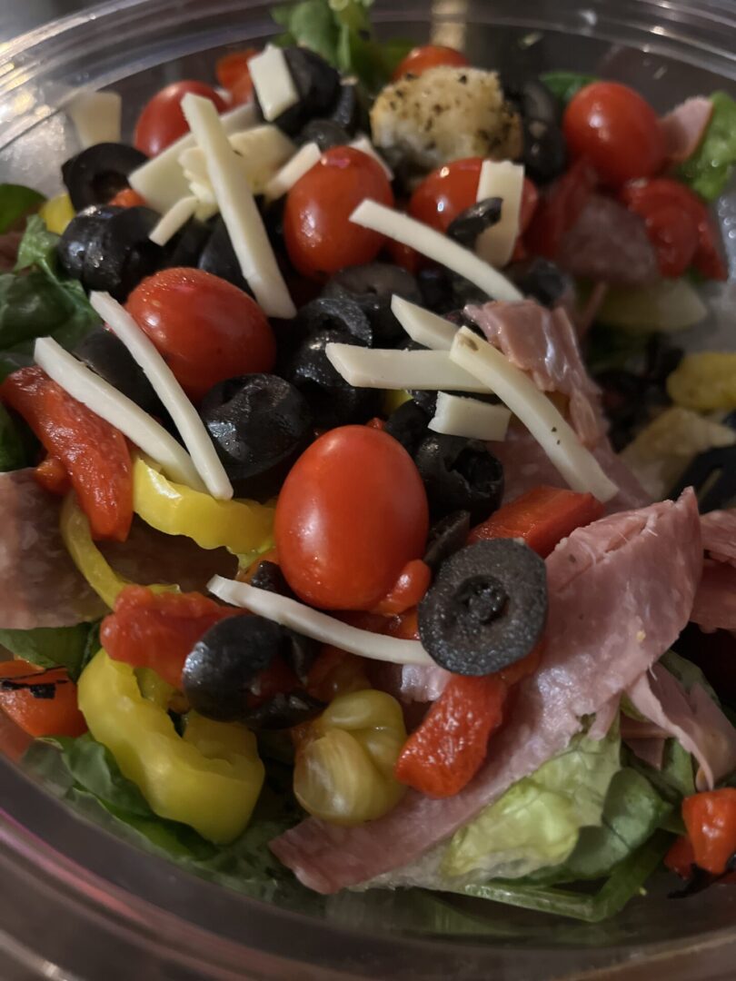 A salad with tomatoes, olives and cheese.