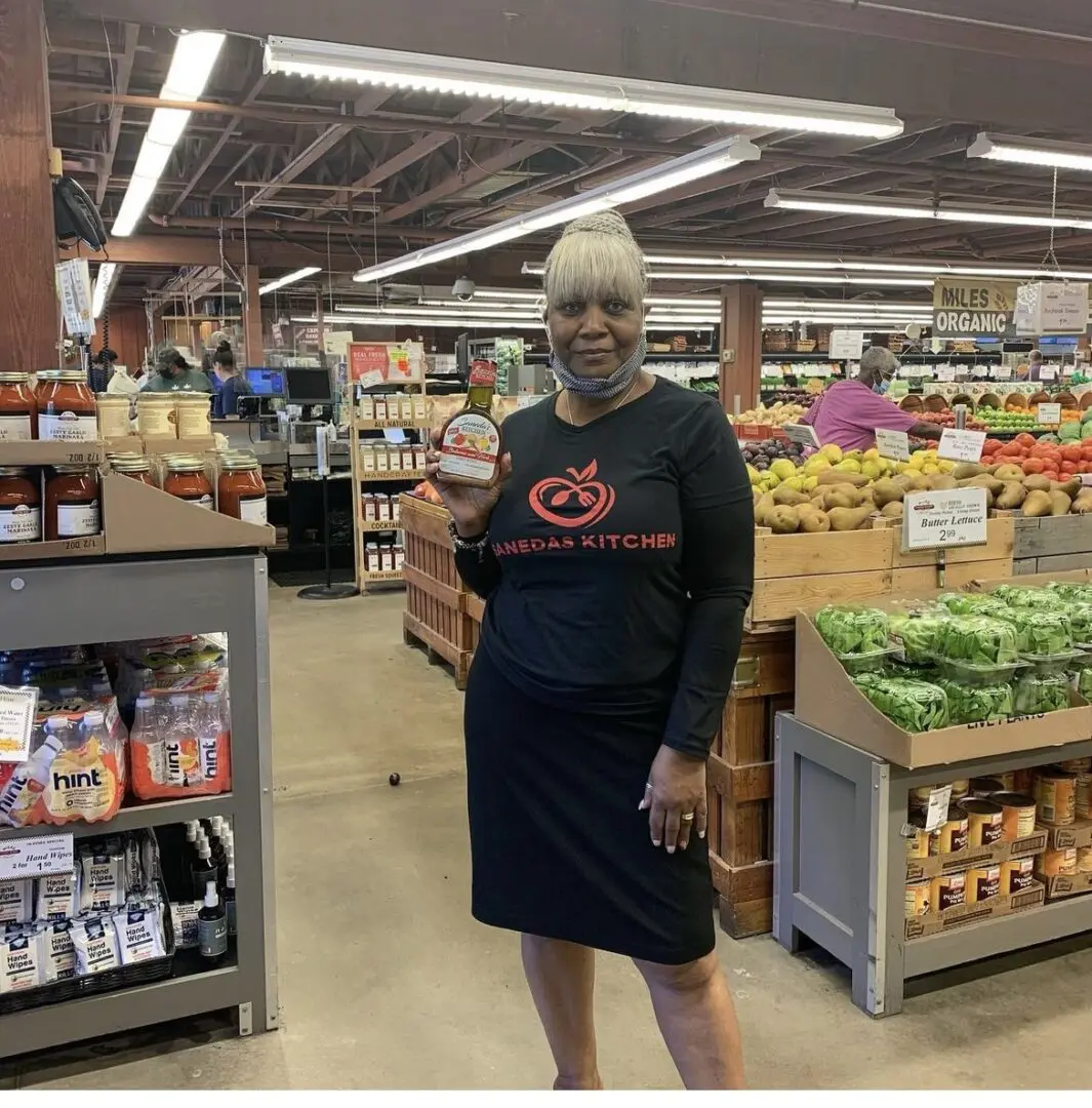 A woman standing in the middle of an aisle.