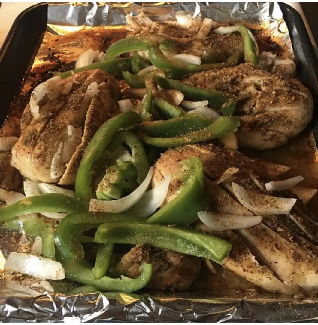 A pan of food with chicken and peppers.