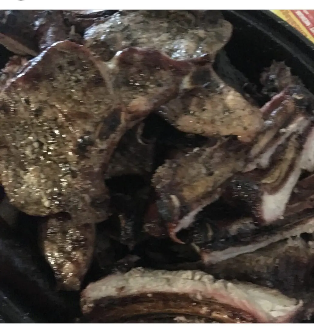 A close up of some meat on the grill